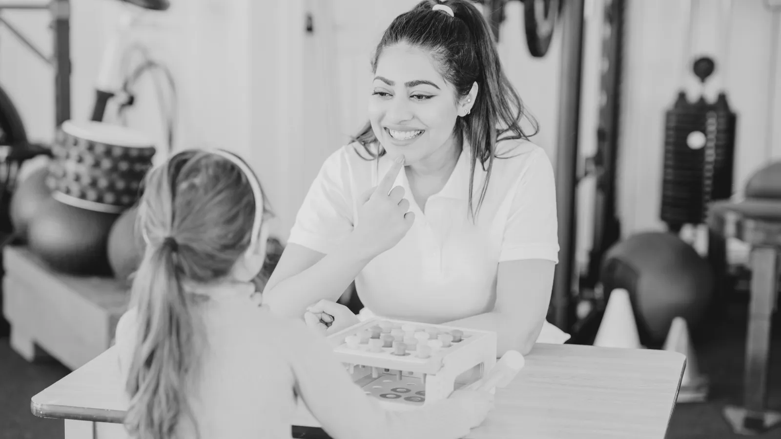 A speech therapist working with a young child at Orchid Academy in Washington.